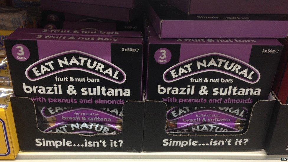 Eat Natural brazil and sultana cereal bars on supermarket shelf.