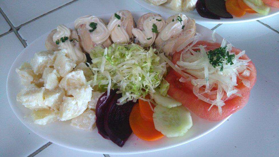 A plate of seafood with salad