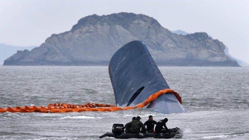 A vessel involved in salvage operations passes near the upturned South Korean ferry Sewol in April 2014