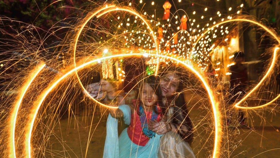 A family celebrates Diwali with firecrackers at Shivaji Park, Dadar on November 3, 2021 in Mumbai, India.