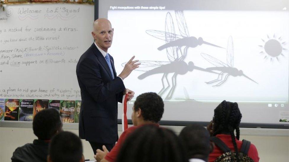 Florida Governor Rick Scott talks with students on the first day of school in the Wynwood neighbourhood of Miami.