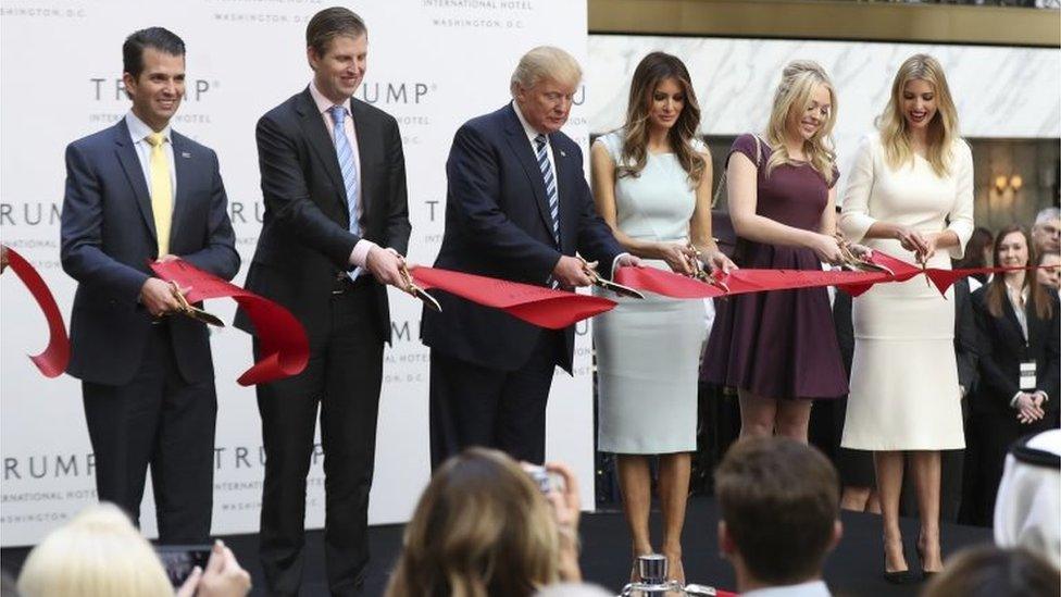 Donald Trump, together with his family, from left, Donald Trump Jr, Eric Trump, Trump, Melania Trump, Tiffany Trump and Ivanka Trump, cut the ribbon during the grand opening of Trump International Hotel in Washington