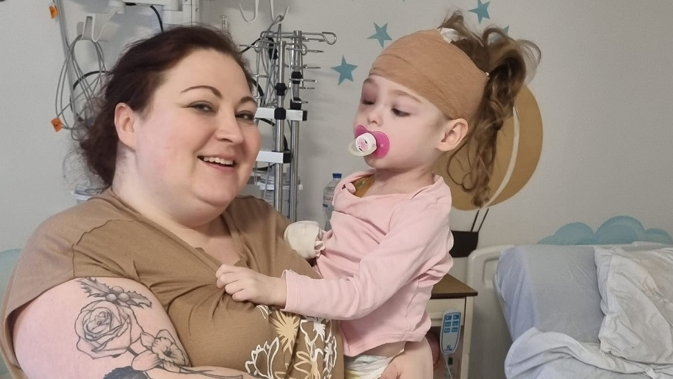 Katie Jennings holding her daughter Rachel in hospital