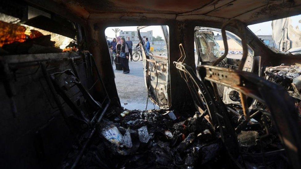 Palestinians at a destroyed World Central Kitchen (WCK) air strike