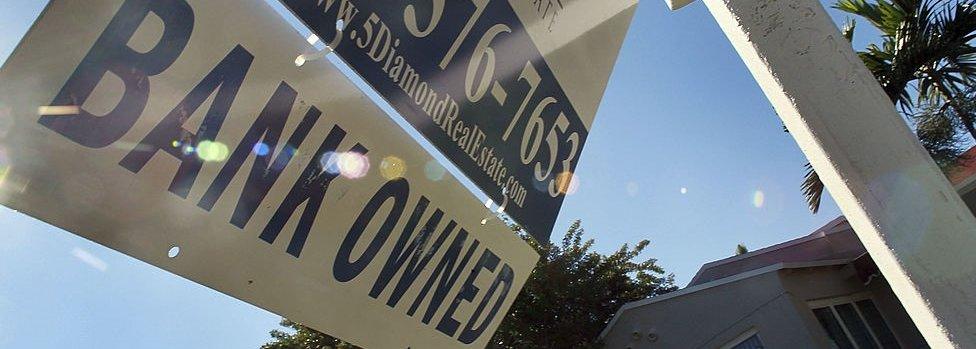 A bank owned sign is seen in front of a foreclosed home on December 7, 2010 in Miami, Florida.