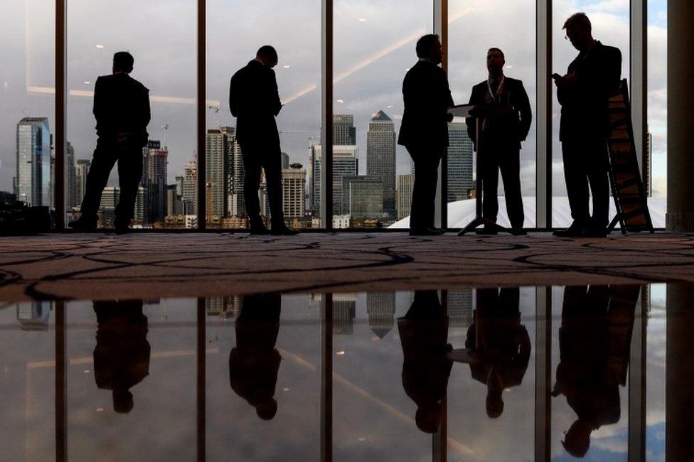 Business people with Canary Wharf in background