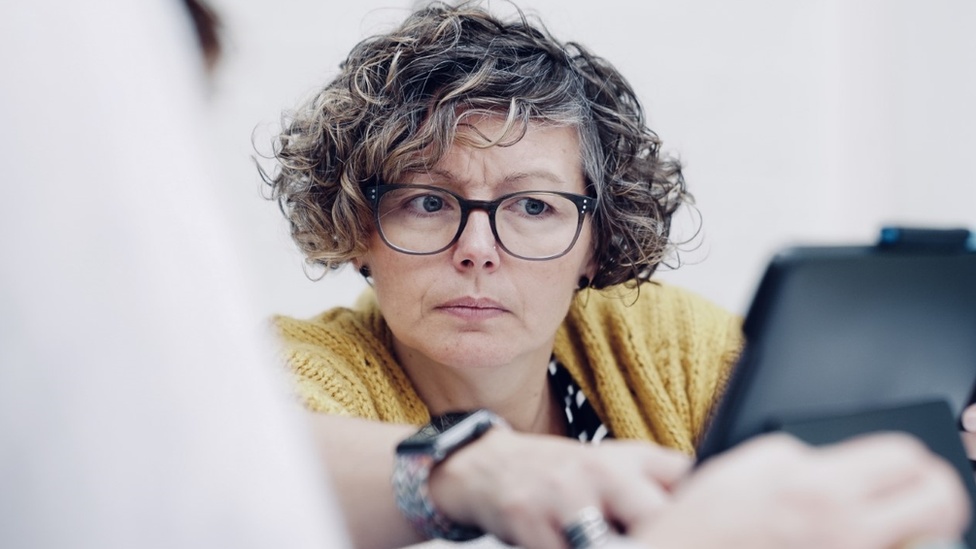 Lynn Stewart Taylor looking at a screen