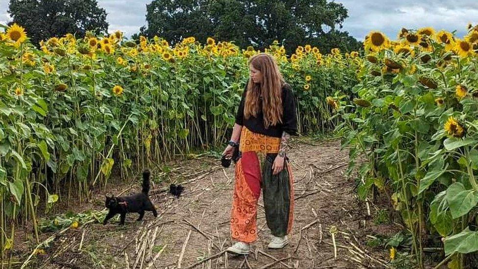 A woman walking her cat