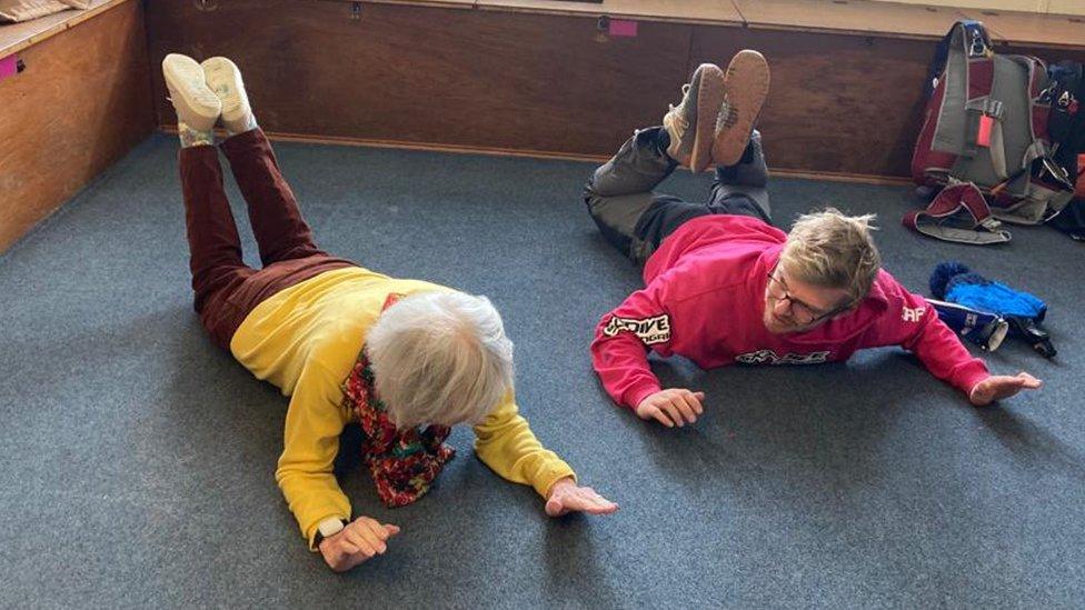 Shirley and instructor seen practising skydive moves