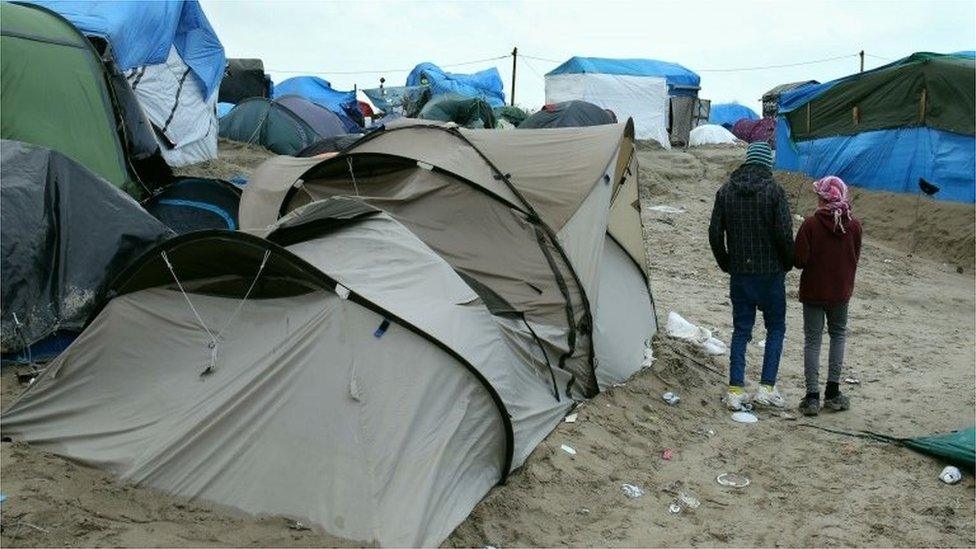 Children walking among the tents at Calais Jungle camp