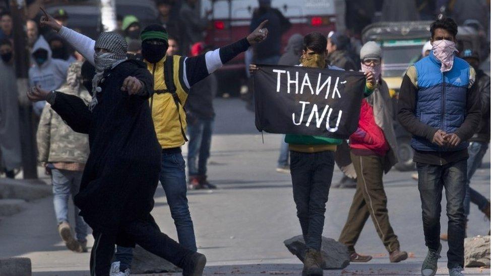 A Kashmiri Muslim protester holds a banner saying "Thanks JNU (Jawaharlal Nehru University)" during a protest in Srinagar, Indian controlled Kashmir, Friday, Feb. 19, 2016.