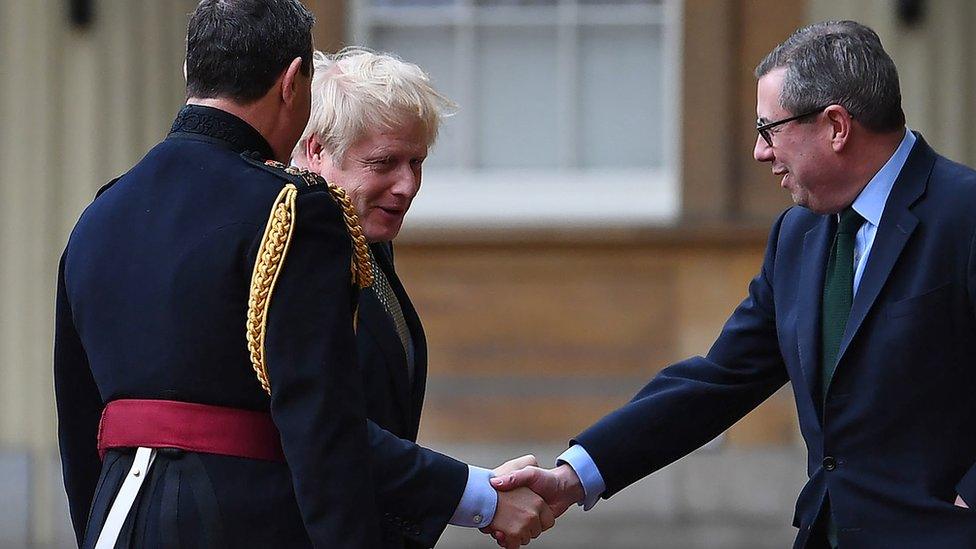 Sir Edward Young (r) welcomes Boris Johnson to Buckingham Palace following his December 2019 election victory