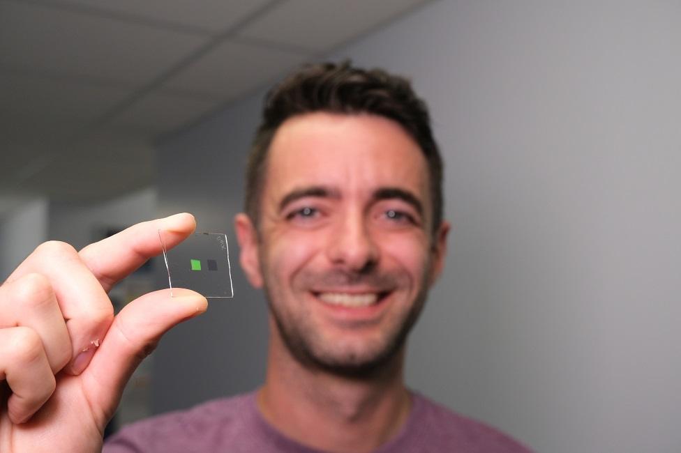 Dr Alasdair Clark holding up a scaled-up version of the materials that make up the "tongue"