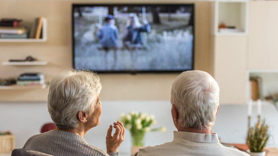 Elderly couple watching TV