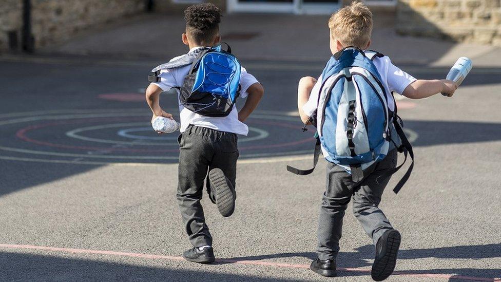 Boys running in schoolyard