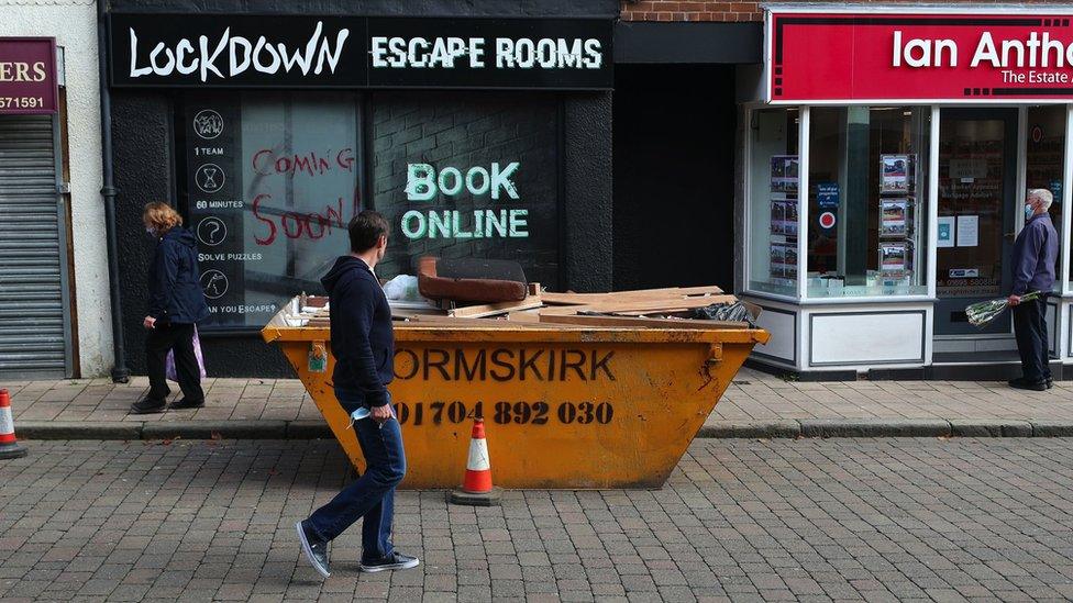 A man walking past escape rooms in Ormskirk, Lancashire