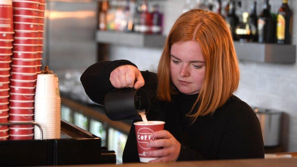 A barista makes a coffee.