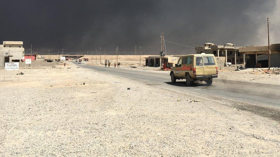 Oil smoke blocks out the sky in Qayyarah