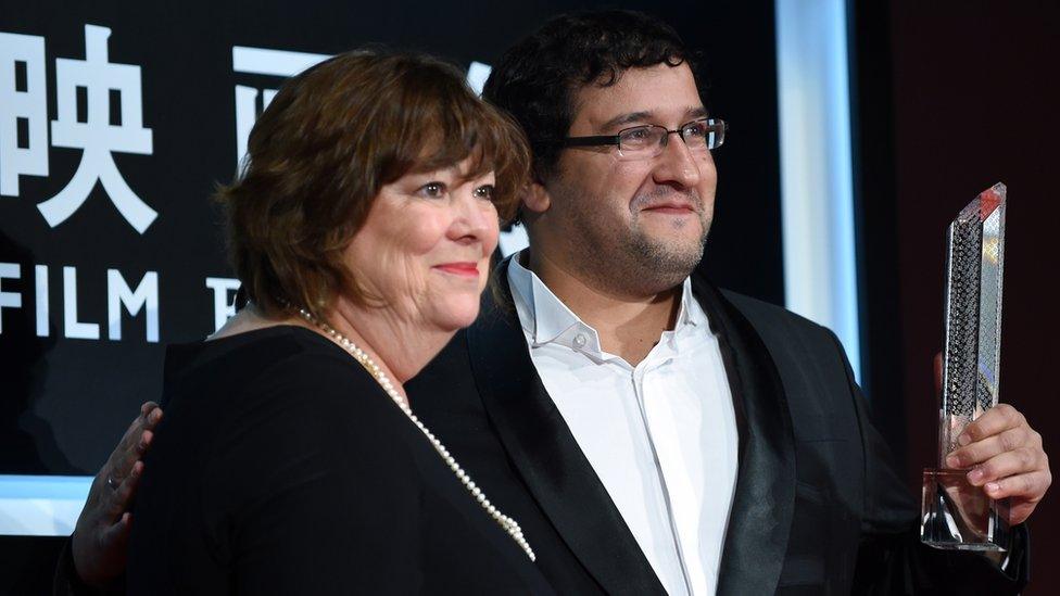 Test director Alexander Kott (R) displays the trophy beside British casting director and jury of the festival Debbie McWilliams