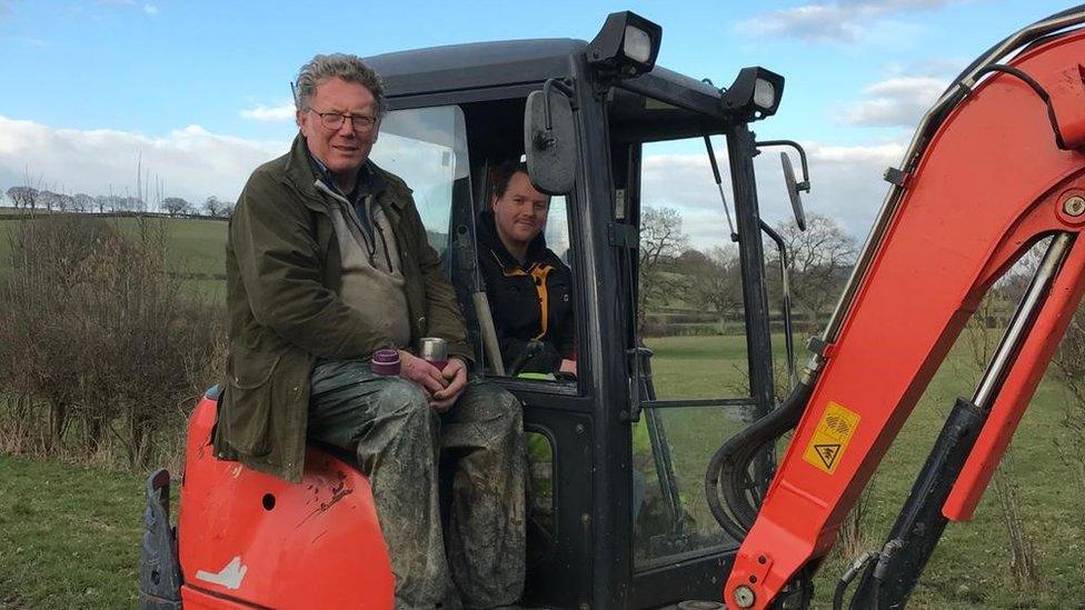 John sat on a tractor