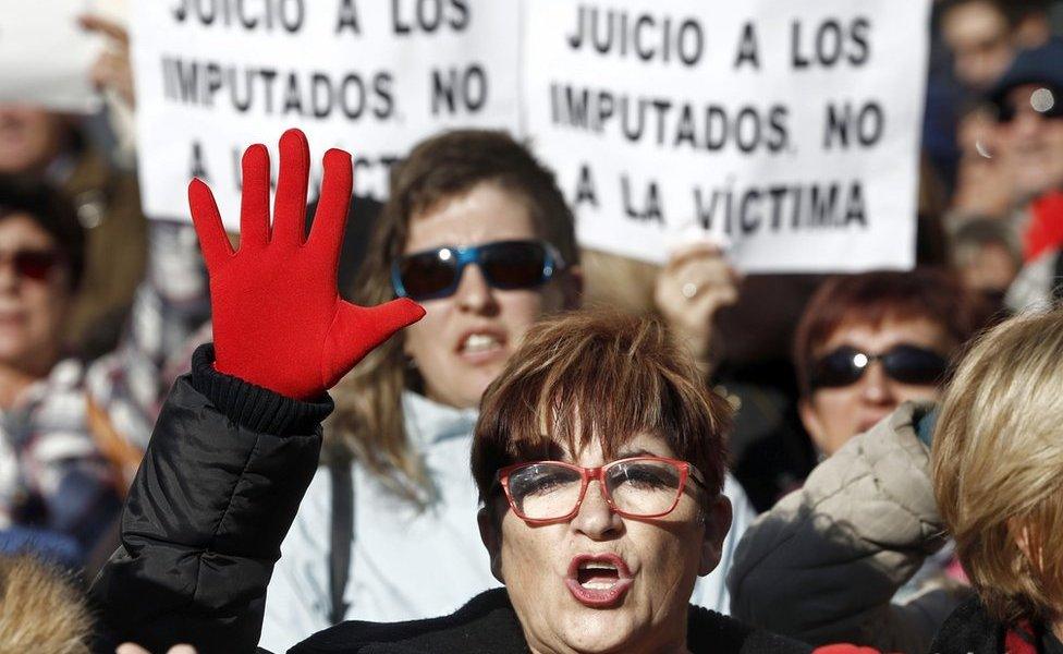 Protesters hold banners that read "Trial against defendants, not against the victim" during a protest held at the Superior Court of Navarra