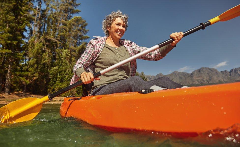 older woman in canoe