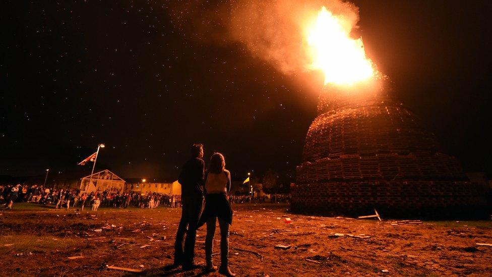 People watch the bonfire at Hopewell Square in Belfast's Shankill area