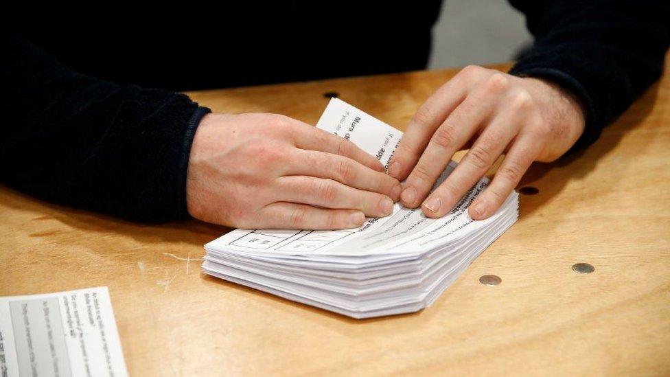 Someone counting ballots