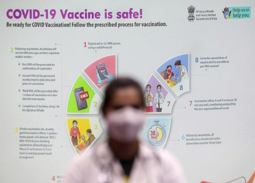 A doctor waits near a vaccination guideline poster in a Covid-19 vaccination centre during a second phase of mock vaccinations in Kolkata, India, 08 January 2021. Drug Controller General of India (DCGI) has approved the emergency use of coronavirus vaccine developed by AstraZeneca and Oxford University.