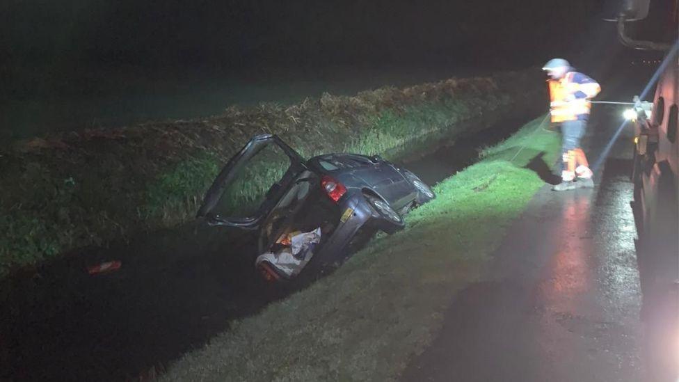Car being pulled from dyke