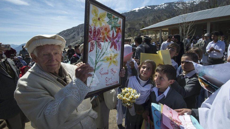 Maj Langlands holding up a picture on the day he retired