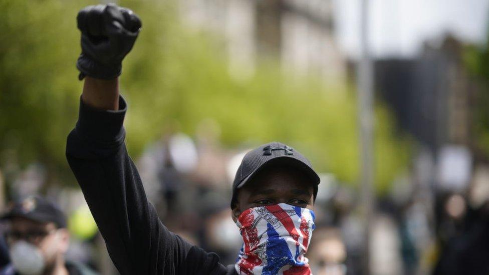 man-with-mask-with-fist-in-the-air.