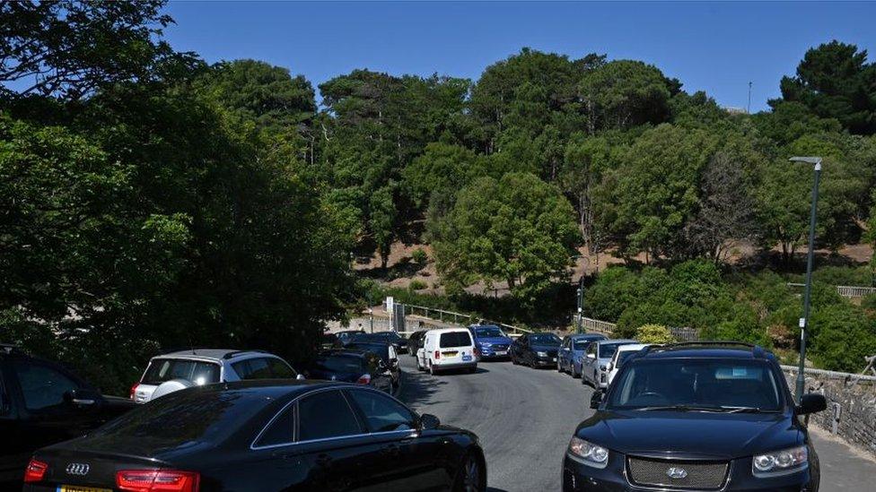 Cars parked on the street on a hot day