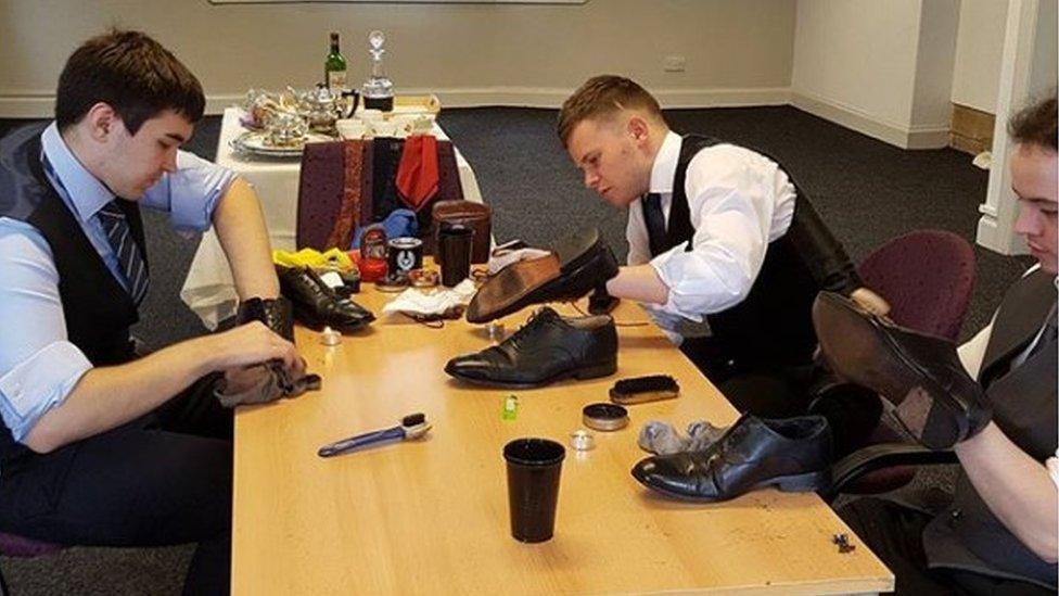 Trainee butlers shoe polishing