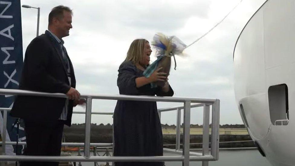 Janice McDowall breaking the bottle against the ship's bow