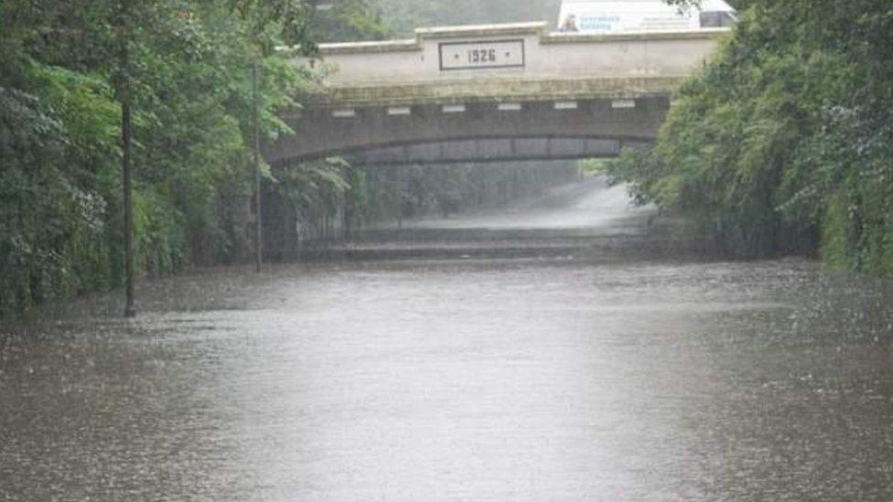 Floodwater in road under a bridge