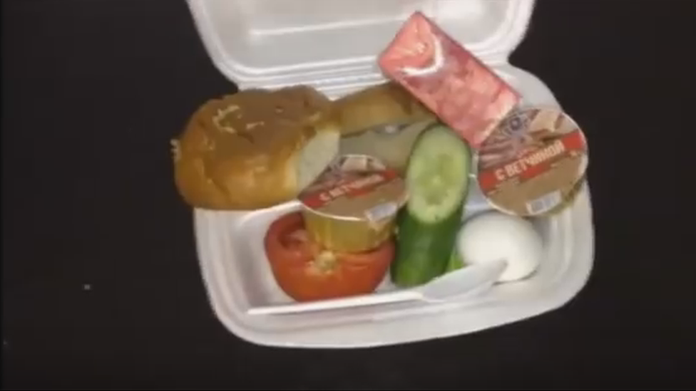 A still from the video showing the polystyrene box with the food inside