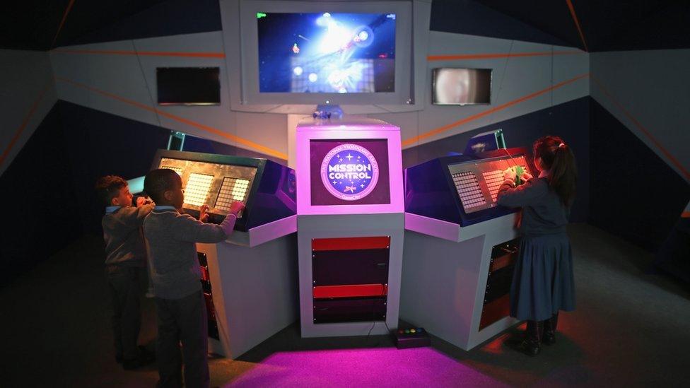 Children play on Mission Control in the National Videogame Arcade