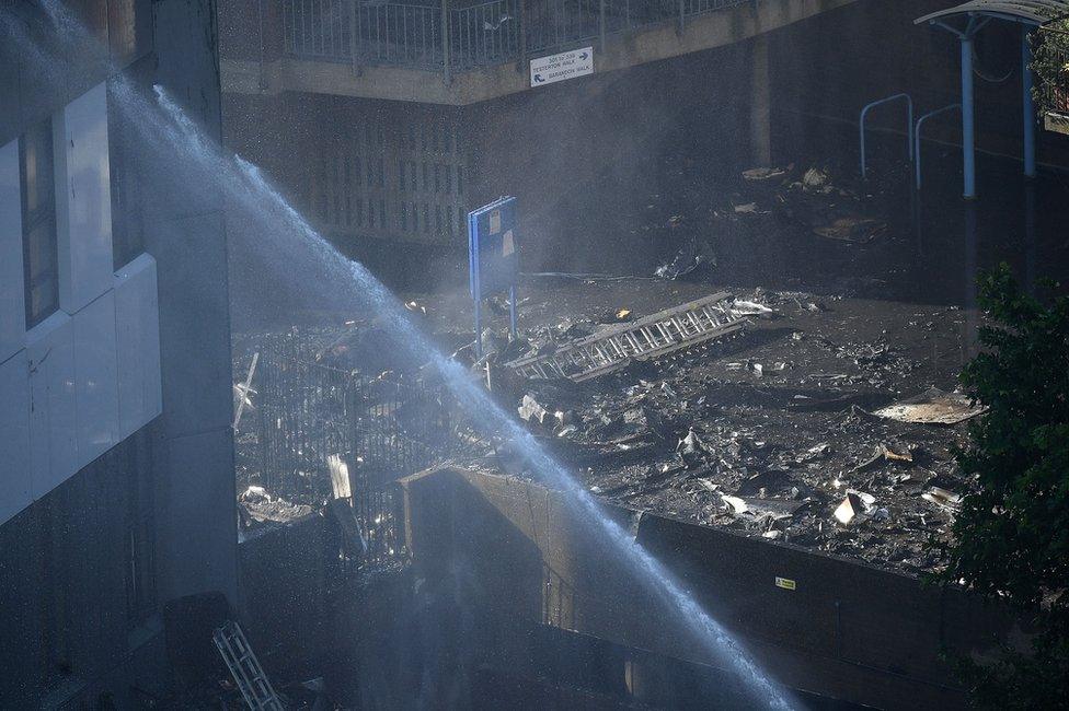 Firefighters use a jet to tackle the huge fire at Grenfell Tower in Latimer Road, West London