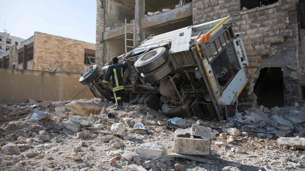 A Syrian man checks the damage following an air strike in the rebel-held Ansari district in the northern Syrian city of Aleppo on September 23, 2016