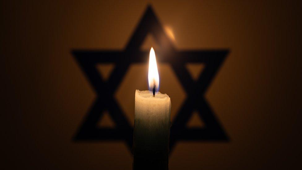 candle in front of star of David.