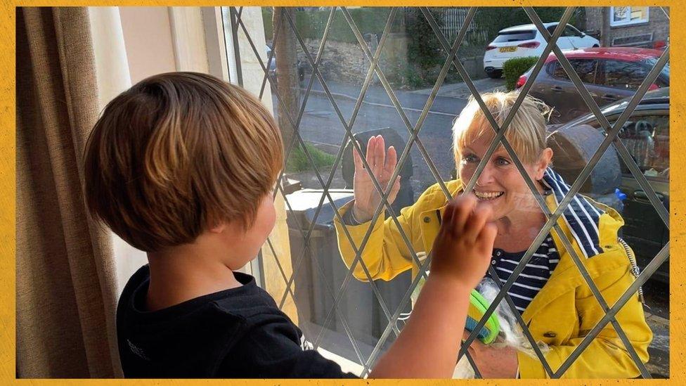 A woman waving at her grandson