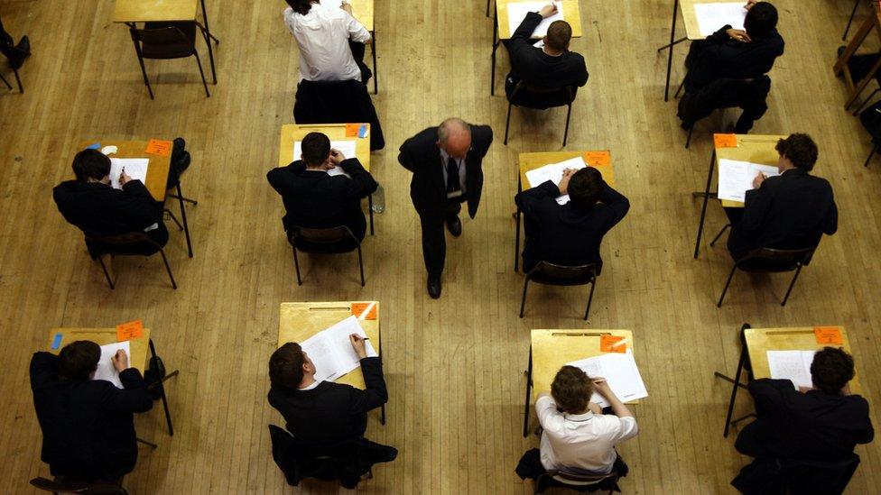 An exam hall with students and an adjudicator