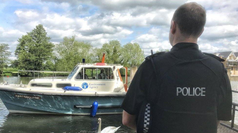 Policeman with an Environment Agency boat