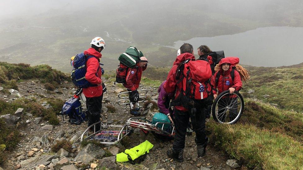 Mountain rescue volunteers on the Foxes Path as the Coastguard helicopter attempted to reach the casualties in thick mist and driving rain