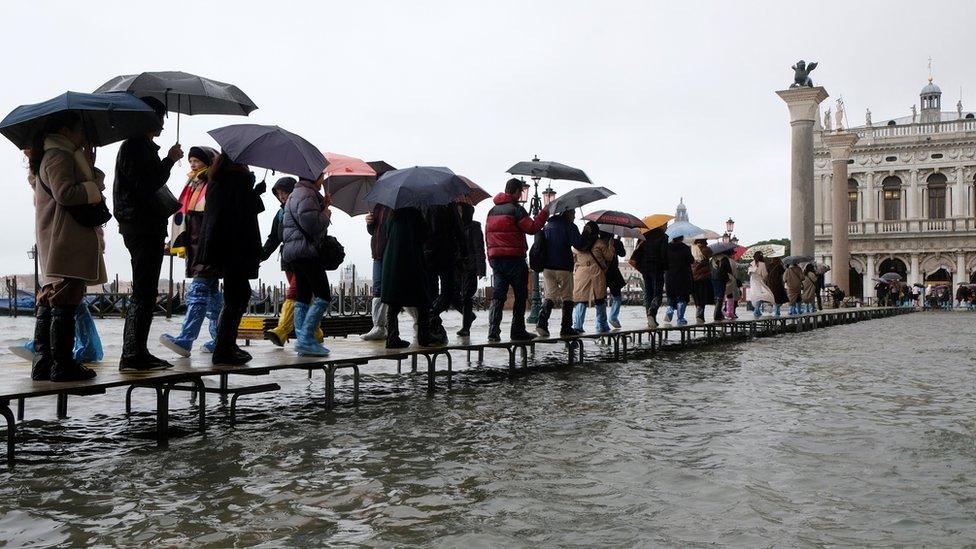 people-walking-catwalk-floods.