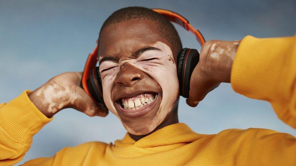 boy-smiling-with-headphones-on.