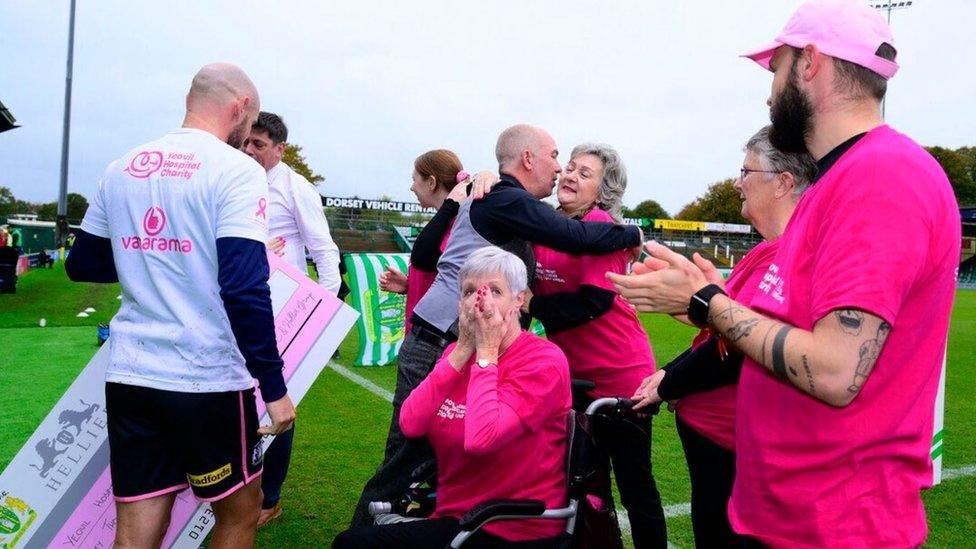 Emotional people after the announcement of the funds on the Yeovil Town pitch