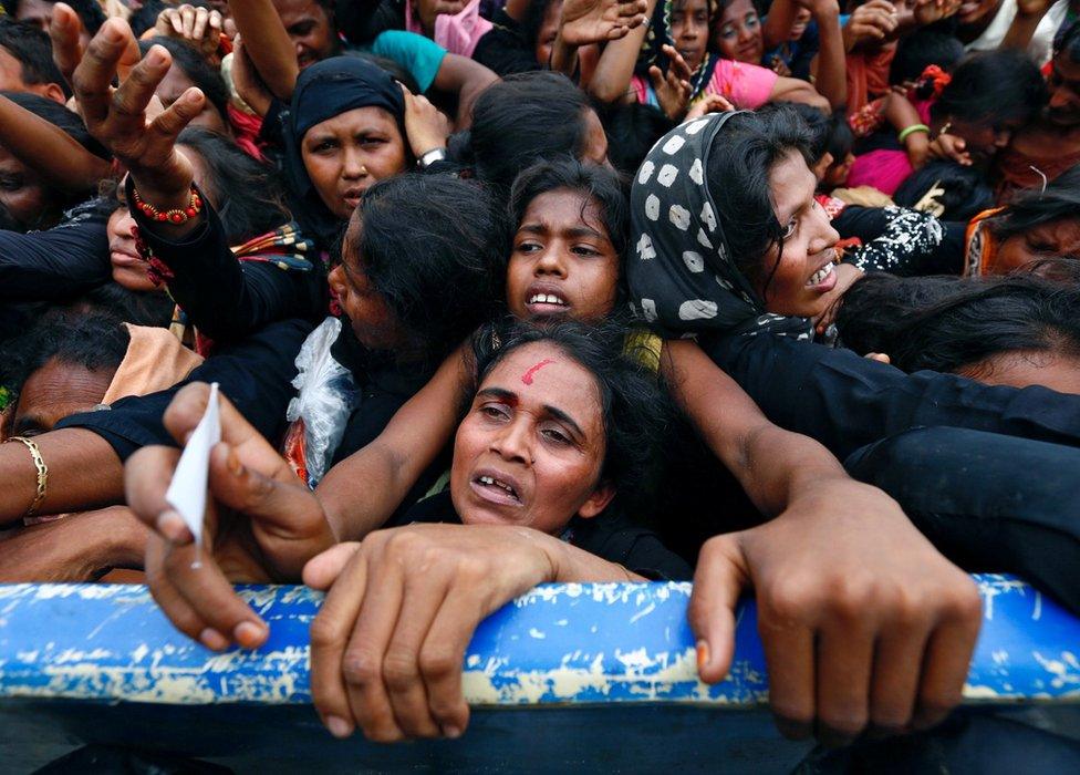 A Rohingya refugee woman's forehead bleeds as she jostles for aid in Cox's Bazar, Bangladesh 20 September 2017.