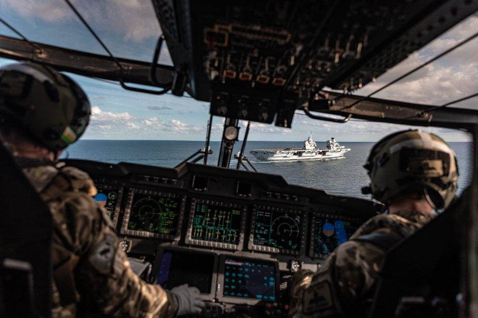 A view through the cockpit window of a helicopter